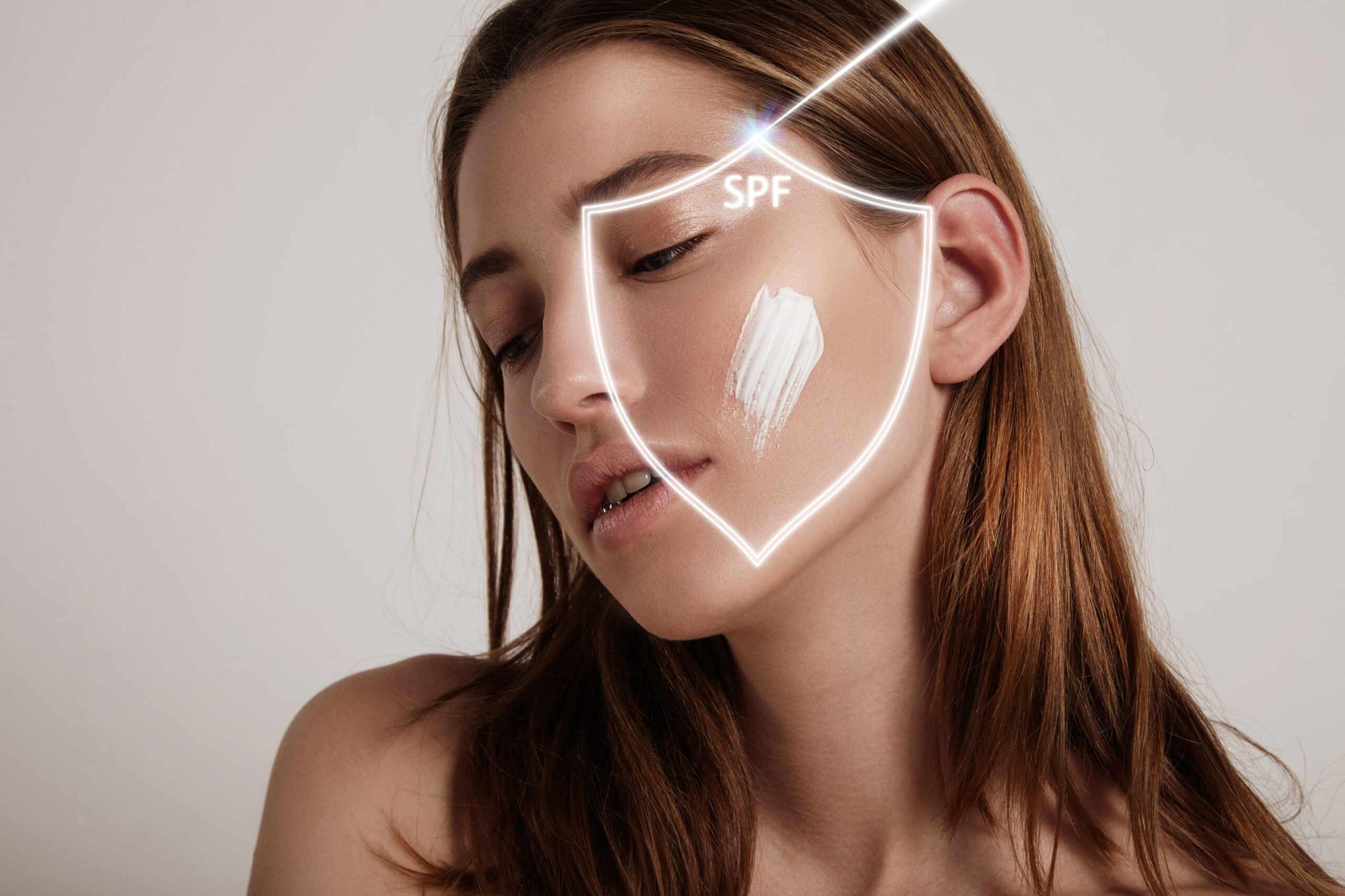 woman's face into a shield makes spf protection from ray