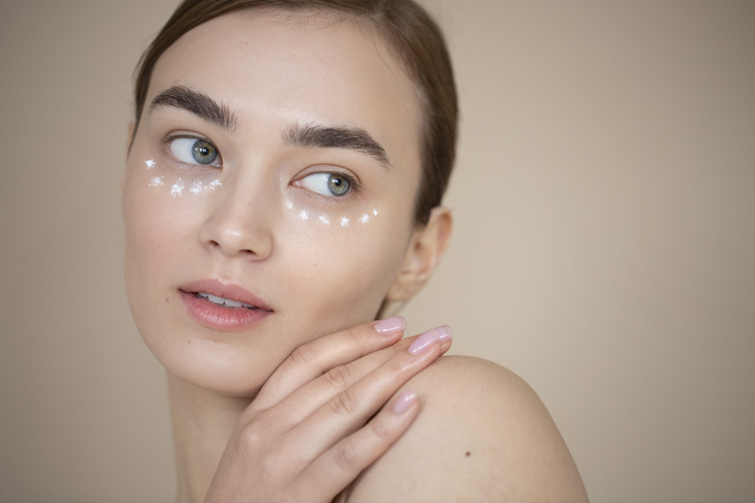 portrait-beautiful-woman-with-clear-skin-using-eye-cream